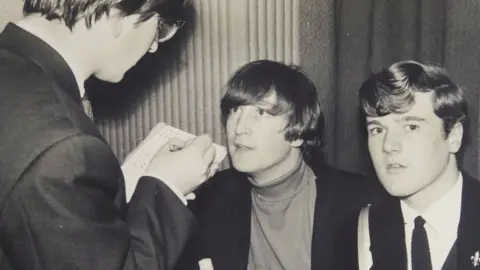 David Duggleby Auctioneers John Lennon (middle) interviewed by students in 1964