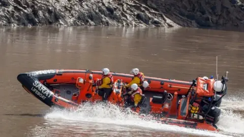 Severn Rescue David Deveney skippering a lifeboat as it does a fast turn in the river.