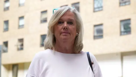 John Fairhall/BBC Belinda Cross standing in the courtyard at The Mill in Ipswich