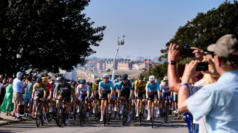 PA Media Tour of Britain cyclists with onlookers