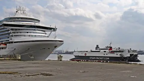 El Pollock/Geograph the Steam Packet catamaran passes the Caribbean Princess, and the derelict Princes Jetty