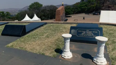 Getty Images A picture taken on September 12, 2019 shows an empty grave next to the grave of late Zimbabwean President's first wife Sally Mugabe, who lies buried at the National Heroes Acre in Harare, as speculations continue as to where the final resting place of the late president Robert Mugabe will be.