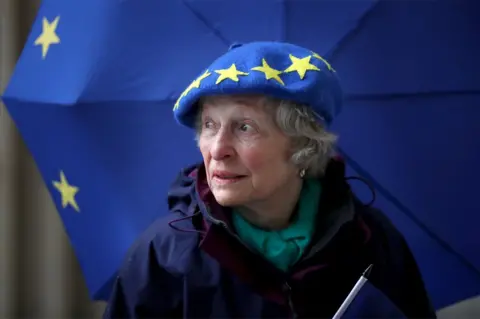 Jane Barlow/ PA Maggie Moss stands with EU branded dress.