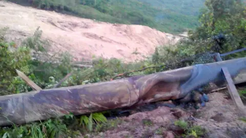 Jerome Kay via Reuters A supplied image shows a landslide and damage to a road located near the township of Tabubil after an earthquake that struck Papua New Guinea's Southern Highlands