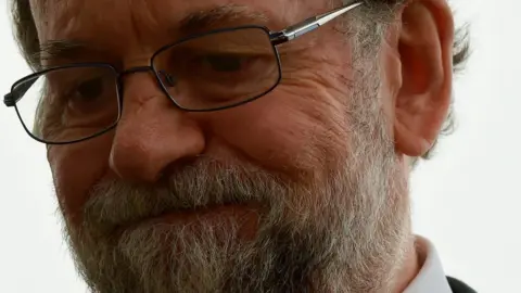 AFP Spanish Prime Minister Mariano Rajoy listens to firemen at a control point in Pazos de Borben, near Redondela, north-western Spain