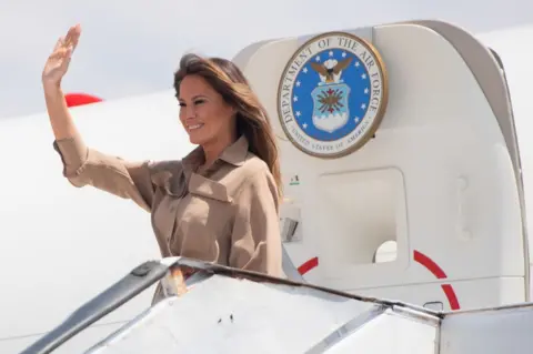 AFP Melania Trump waves as she lands in Malawi