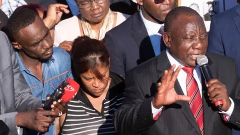 Getty Images President Ramaphosa talking to people