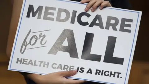 Getty Images A "Medicare for all" sign.