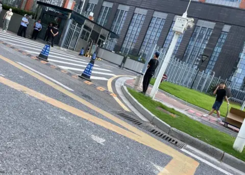 Free HUang Xuewin and Wang Jianbing Campaign Picture provided by the spokesperson of the campaign to free the activists appears to show heavy police presence around the court