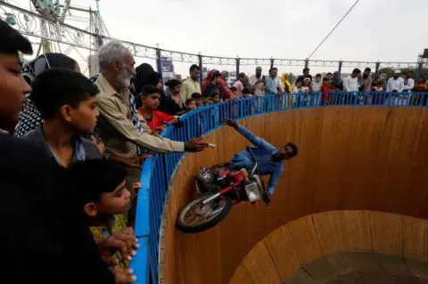 Akhtar Soomro / Reuters A motorcyclist on the wall of death