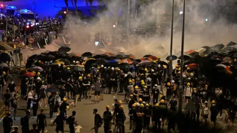 Getty Images Police fire tear gas at Hong Kong protesters