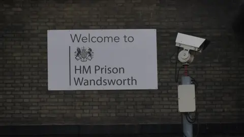 PA Media A general view of signage and security cameras at HMP Wandsworth in London,