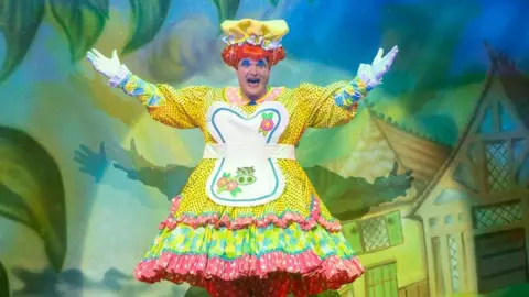 Tim Dickeson Mike Doyle on stage dressed as Madam Trott