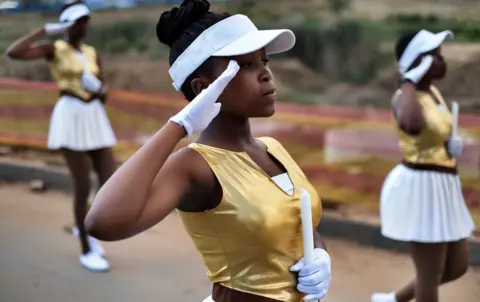 AFP South African majorettes salute as they parade near the house of Winnie Mandela Soweto, Johannesburg, on April 8, 2018.