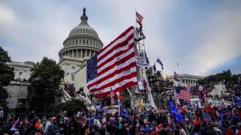 NurPhoto via Getty Images Trump supporters near the US Capitol following a 'Stop the Steal' rally on January 06, 2021