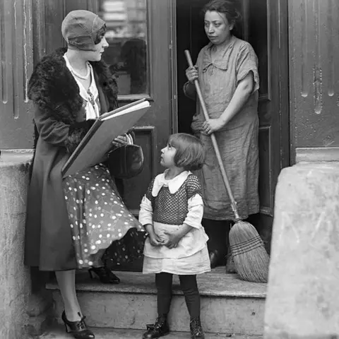 Getty Images A census worker in 1930 speaks to a New York City tenant