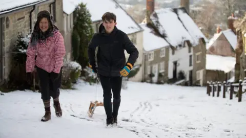 PA Media People sledging on Gold Hill in Shaftesbury Dorset - Andrew Matthews PA Wire