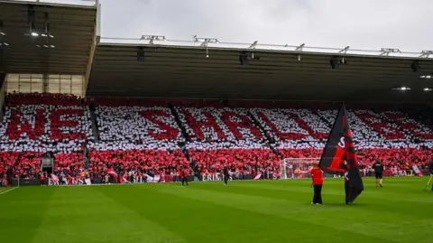 Middlesbrough supporters display hundreds of small banners spelling out: ''We Shall Be'' in the North Stand during the Sky Bet Championship Play-Off Semi-Final 1st Leg between Middlesbrough and Southampton at the Riverside Stadium in Middlesbrough.