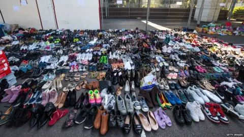 Getty Images Donated shoes sit in the Westway Sports Centre near to the site of the Grenfell Tower fire