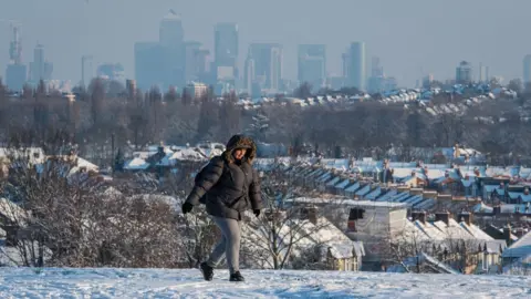 Dominic Lipinski/PA Wire A woman walks over Blythe Hill, in south London