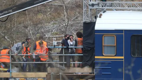 PA Media Tom Cruise on train with film crew