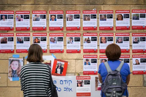 Getty Images Photographs of some of those taken hostage by Hamas during their recent attacks