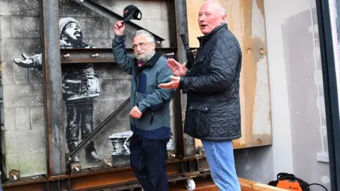 Wales News Service John Brandler and Ian Lewis with the artwork in the background