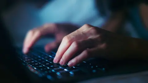 Getty Images Hands typing on a keyboard