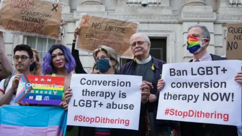 Getty Images Protestors calling for an immediate conversion therapy ban, June 2021