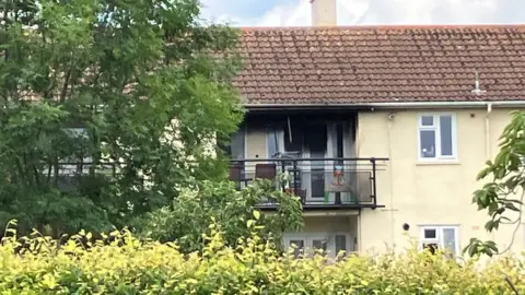 BBC A building with a blackened balcony after a fire