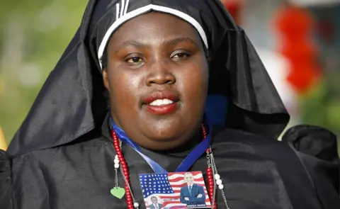 EPA A nun with a badge of Kenya opposition leader Raila Odinga and former US president Barack Obama - Kogelo, Kenya - Monday 16 July 2018