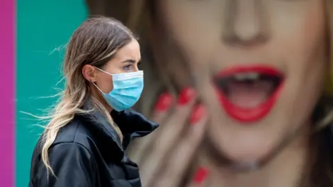 Getty Images Woman wearing face mask