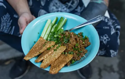 BBC The final result - a bowl of fried tempeh, fried rice and fresh cucumber