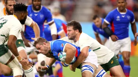 Getty Images Namibian player Wian Conradie is tackled during a Group B game against South Africa.