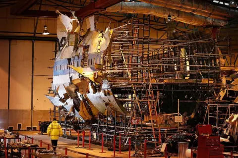 Getty Images A large scaffold with parts of a plane's fuselage assembled around it