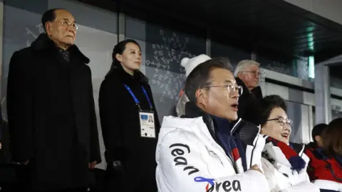 Getty Images South Korean President Moon Jae-in, second from bottom right, stands alongside first lady Kim Jung-sook as the South Korean national anthem is played at the opening ceremony, with top left is Kim Yong Nam, president of the Presidium of North Korean Parliament, and Kim Yo Jong, sister of North Korean leader Kim Jong Un at the PyeongChang 2018 Winter Olympic Games