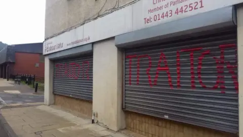 Chris Bryant Shutters on Chris Bryant's offices with graffiti reading 'Traitor'