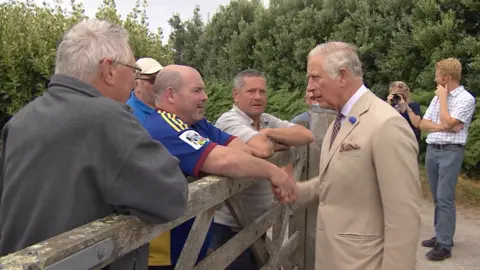 BBC Prince of Wales shaking hands with local people