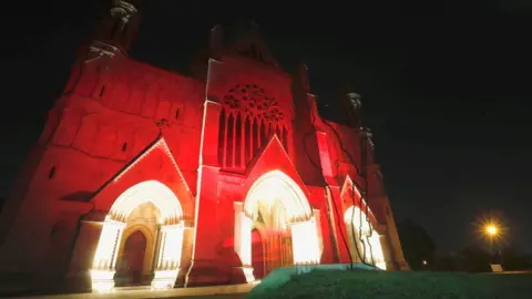 Reuters St Albans Cathedral is bathed in red light