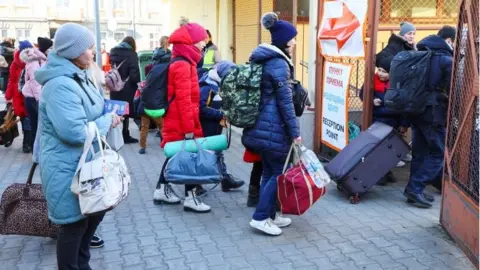 Reuters Refugees arrive from Odesa, after fleeing Russia's invasion of Ukraine, at the border checkpoint in Medyka, Poland (11 March 2022)