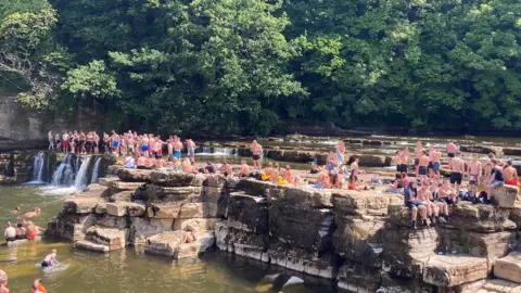 North Yorkshire Police Revellers at Richmond Falls in the heatwave