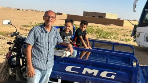 Fadi Ataban/BBC Fadi Atabani and two of his children