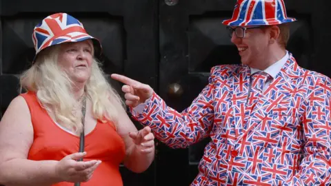 Liam McBurney Friends Jane Bacon and Tristan Fox on a parade route during a Twelfth of July parade in Belfast