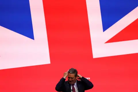 Molly Darlington / Reuters Labour Party leader Sir Keir Starmer reacts after a protester threw glitter on him at the Labour Party annual conference in Liverpool