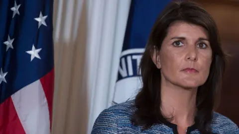 AFP/Getty US envoy to the UN Nikki Haley standing in front of a US flag