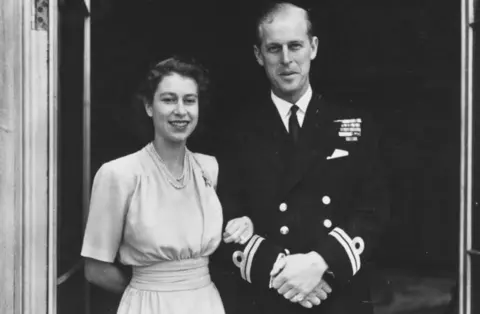 Getty Images Princess Elizabeth and her husband-to-be smile outside Buckingham Palace in 1947, after publicly announcing their engagement