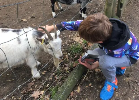 Contributed Boy with goat at Jimmy's Farm