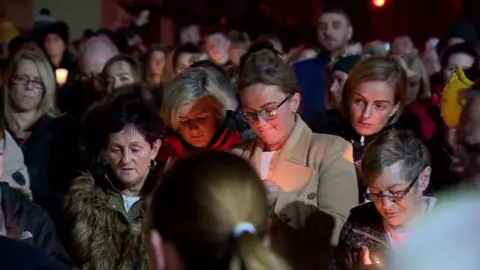 People gather at vigil