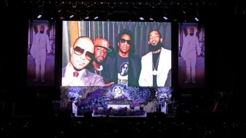 Getty Images Photos shown at Nipsey Hussle's memorial service