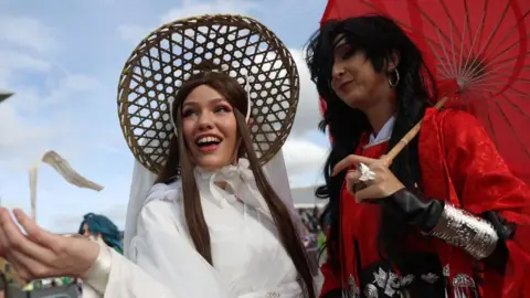 Isabel Infantes/Getty Images Two people dressed as the main characters from Chinese Anime TV series Heaven Official's Blessing